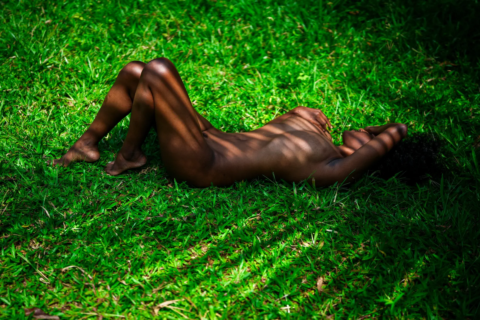 Fine art portrait, reclining on grass