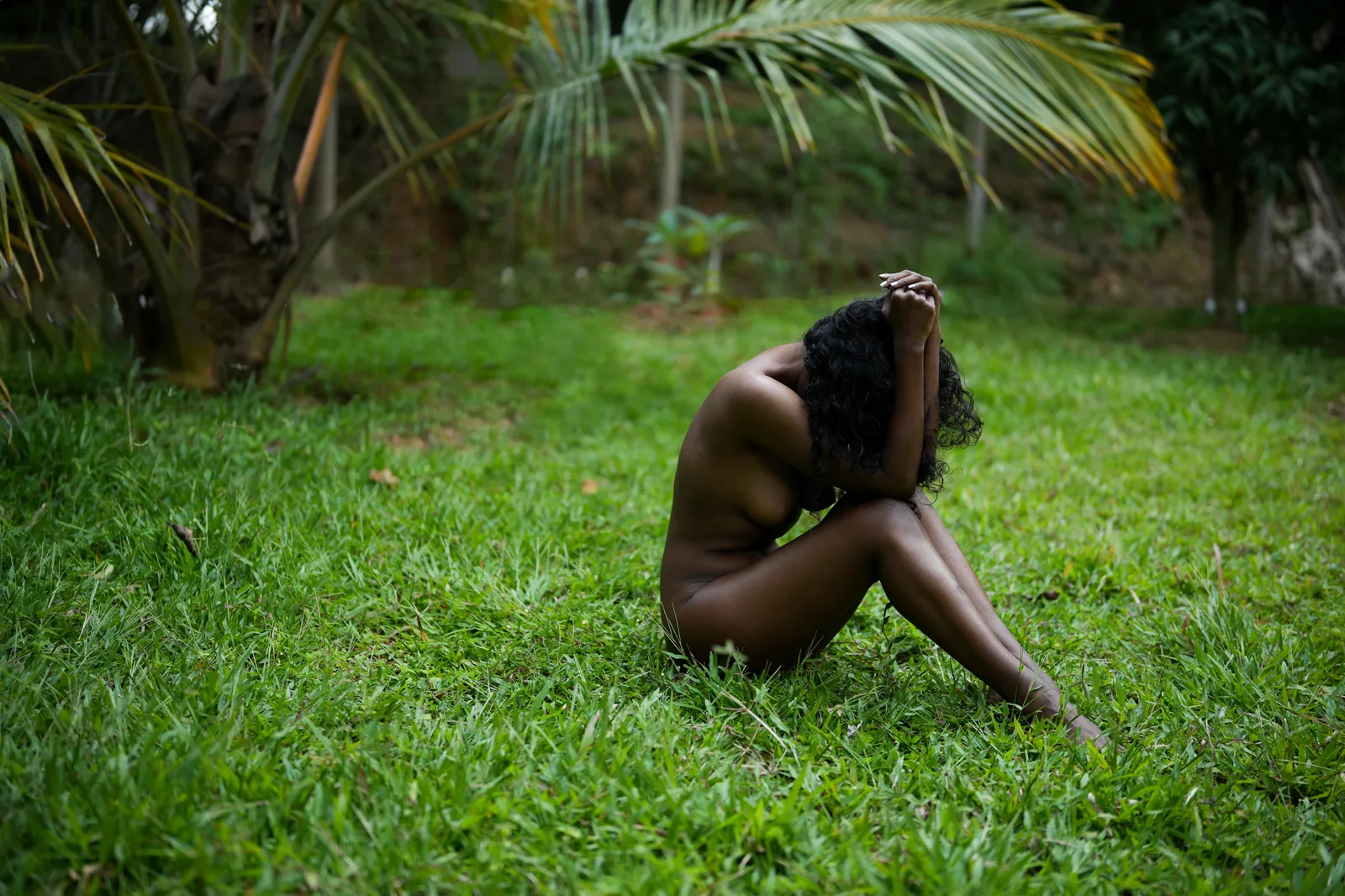 Fine art portrait on grass beneath palms
