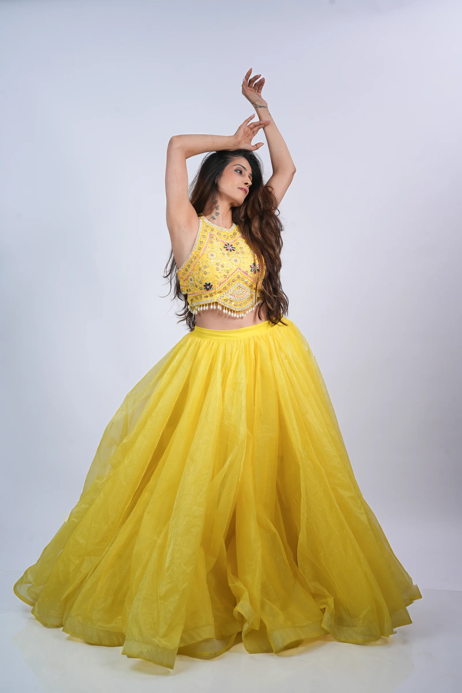 Studio portrait, dance pose in yellow lehenga