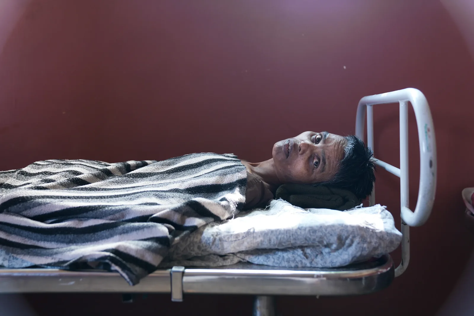 Man resting on a hospital bed