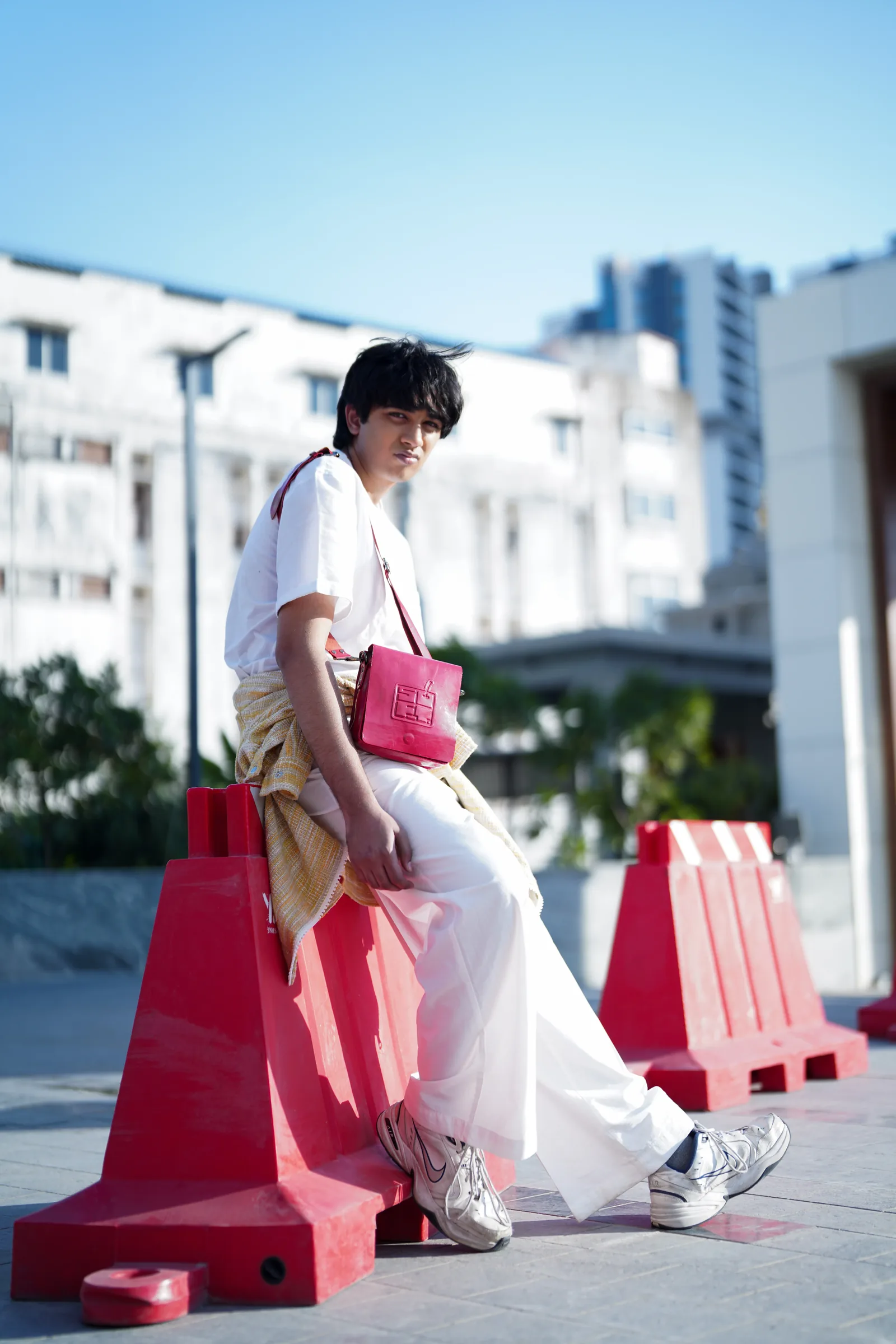 Model with red bag in an urban setting